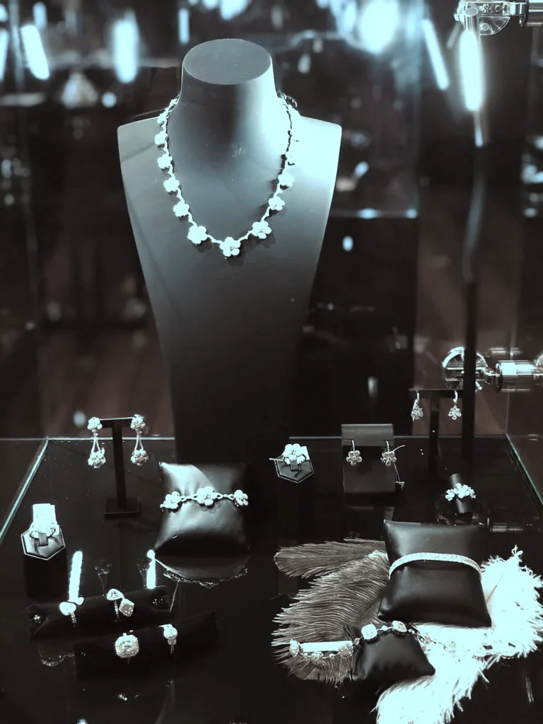 NADESA vitrine with a diamond necklace on a bust and white feathers
